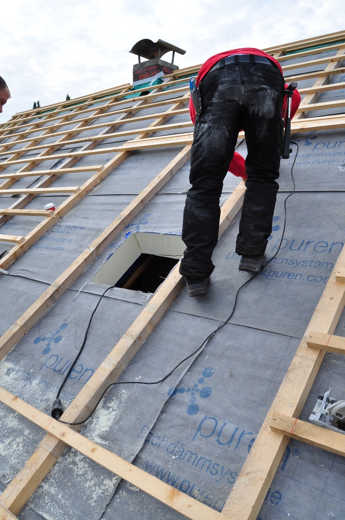 Man working on untiled roof